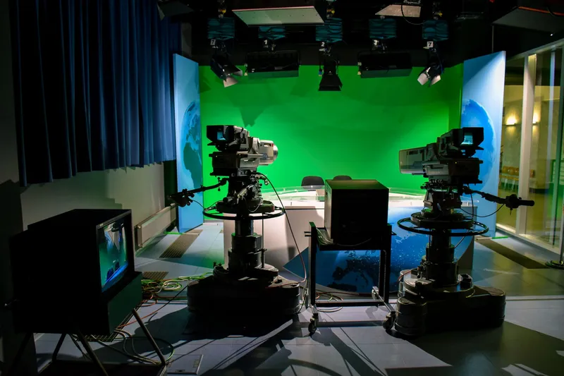 A studio with a green screen and two cameras