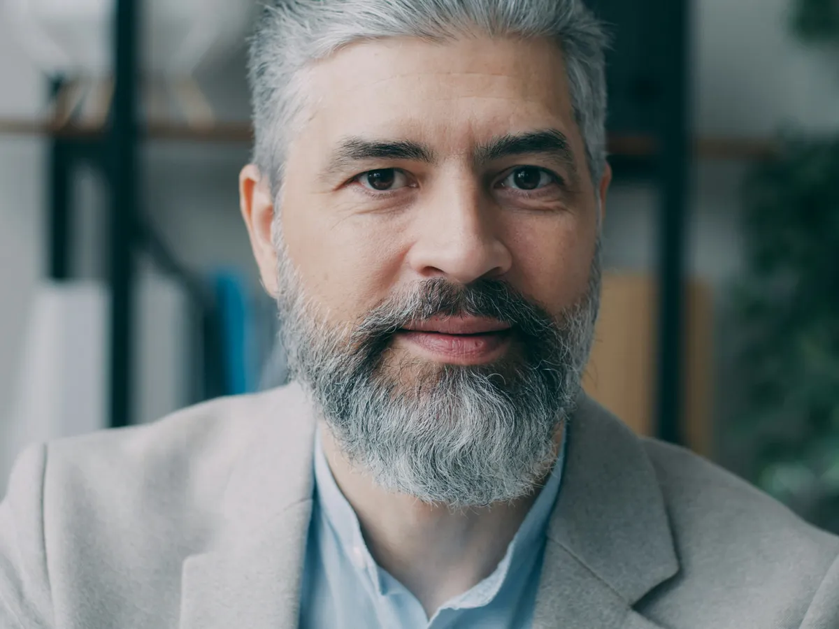An example Hall of Fame inductee, an experienced industry leader in a light grey jacket