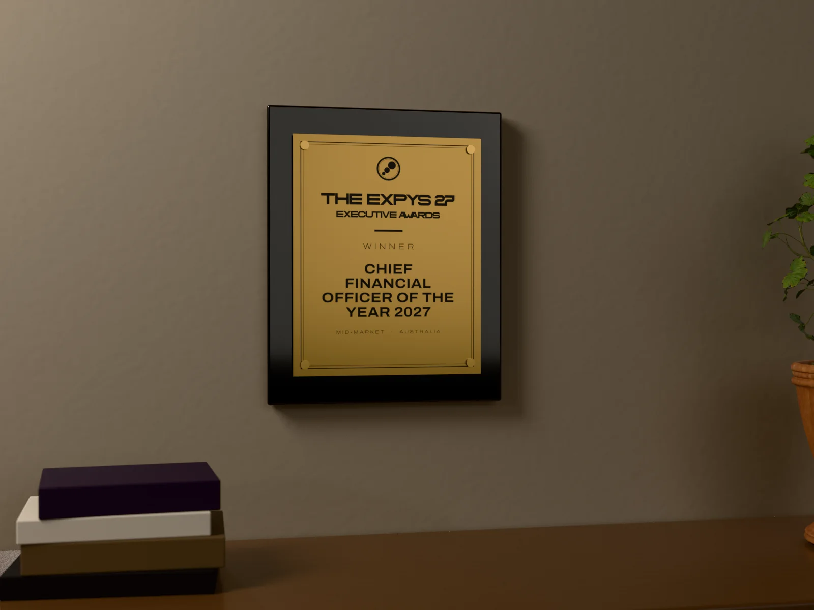 The Executive Awards winner’s wall plaque on an office wall above a walnut sideboard: a brushed brass plate on four brass standoffs, on a black lacquer board, engraved THE EXPYS 27, Executive Awards, Winner, Chief Financial Officer of the Year 2027