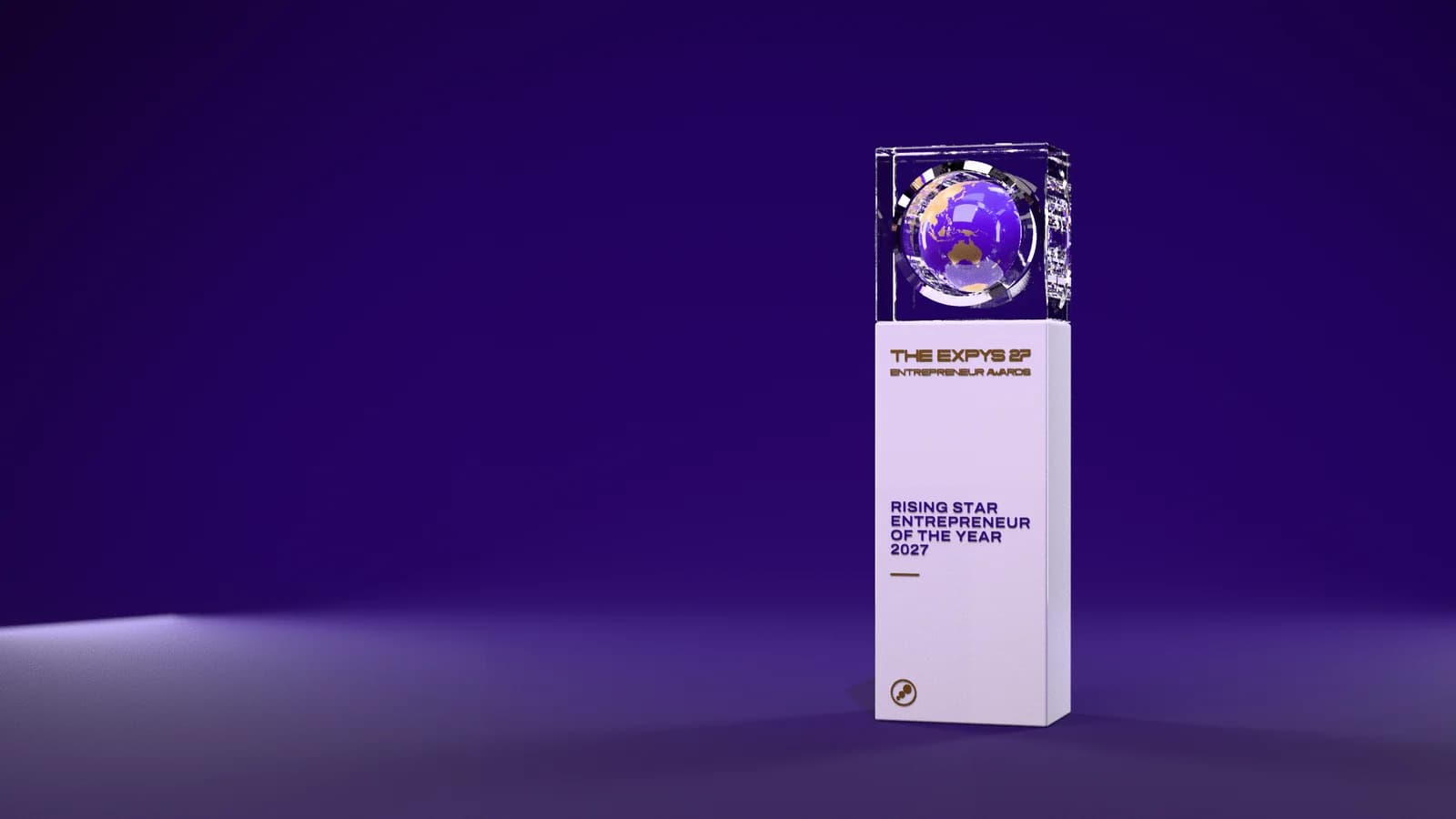 The Entrepreneur Awards trophy on a dark violet stage: a crystal block holding a globe, on a gloss white pillar engraved with the award title, Rising Star Entrepreneur of the Year 2027